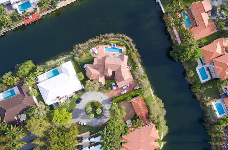 Birdseye view of a housing community with greenery and canals