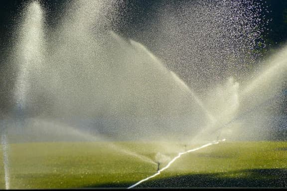 Sprinklers spraying water over grass