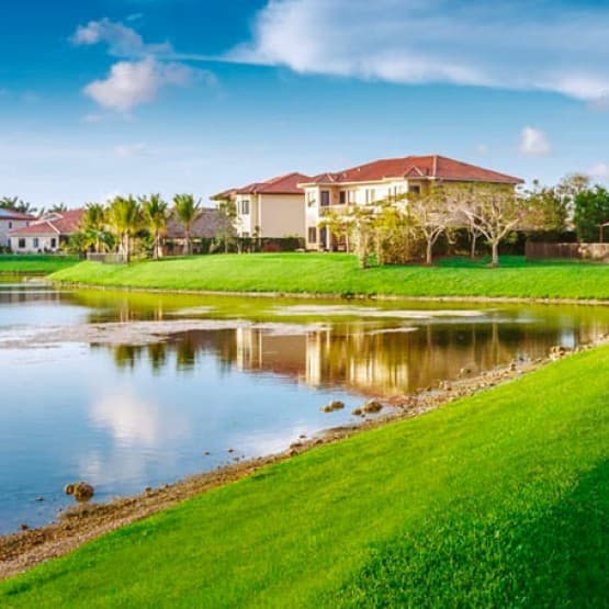 Overlooking green grass and water on a community housing estate