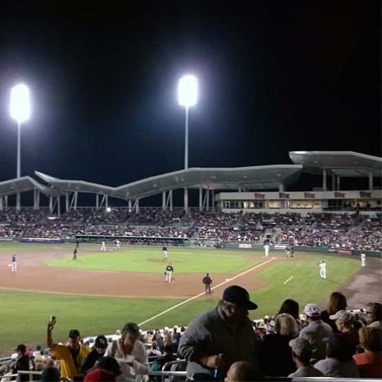 Baseball stadium at night during a game