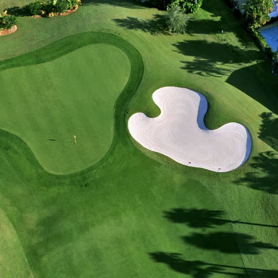 Golf course with a sand bunker next to the putting green