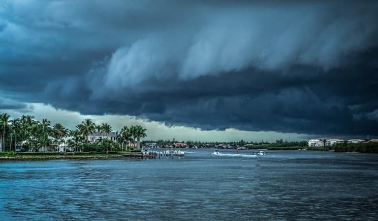 A storm advances over the Florida coast with dark clouds