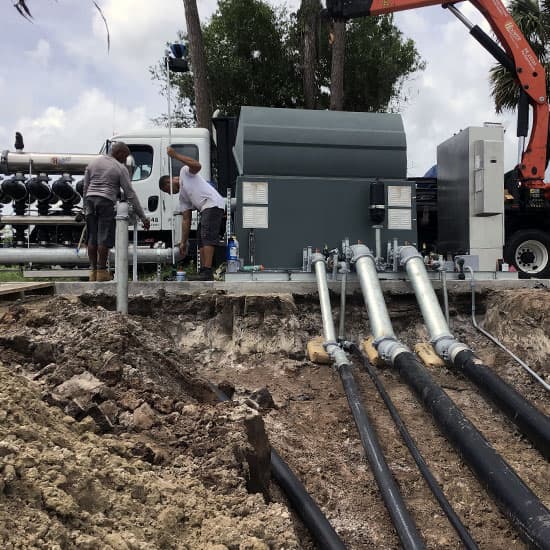 Pipelines being installed into the ground from an irrigation pump