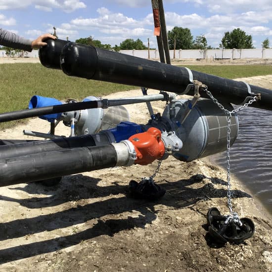 Hoover team working on installing parts of the pipeline into a water resource